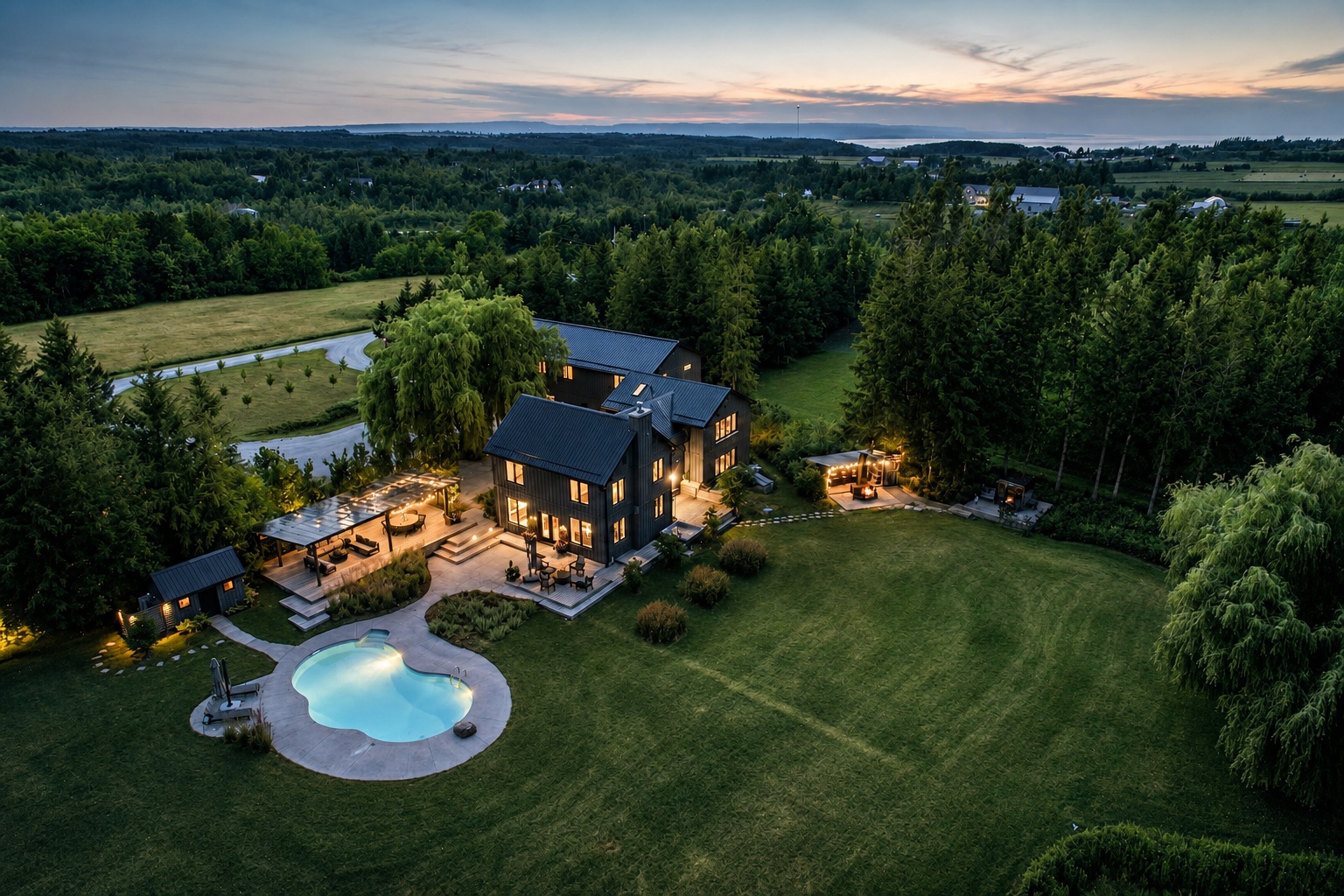 Aerial twilight view of the estate, pool, and Georgian Bay beyond
